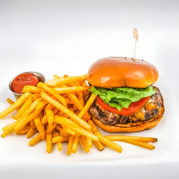 A Ribline BBQ cheeseburger with lettuce and tomato, served with a pile of golden fries and ketchup.