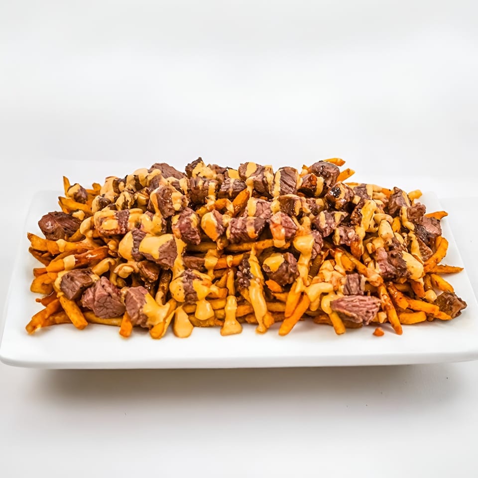 Ribline BBQ's loaded fries, topped with generous chunks of steak and drizzled with cheese sauce.